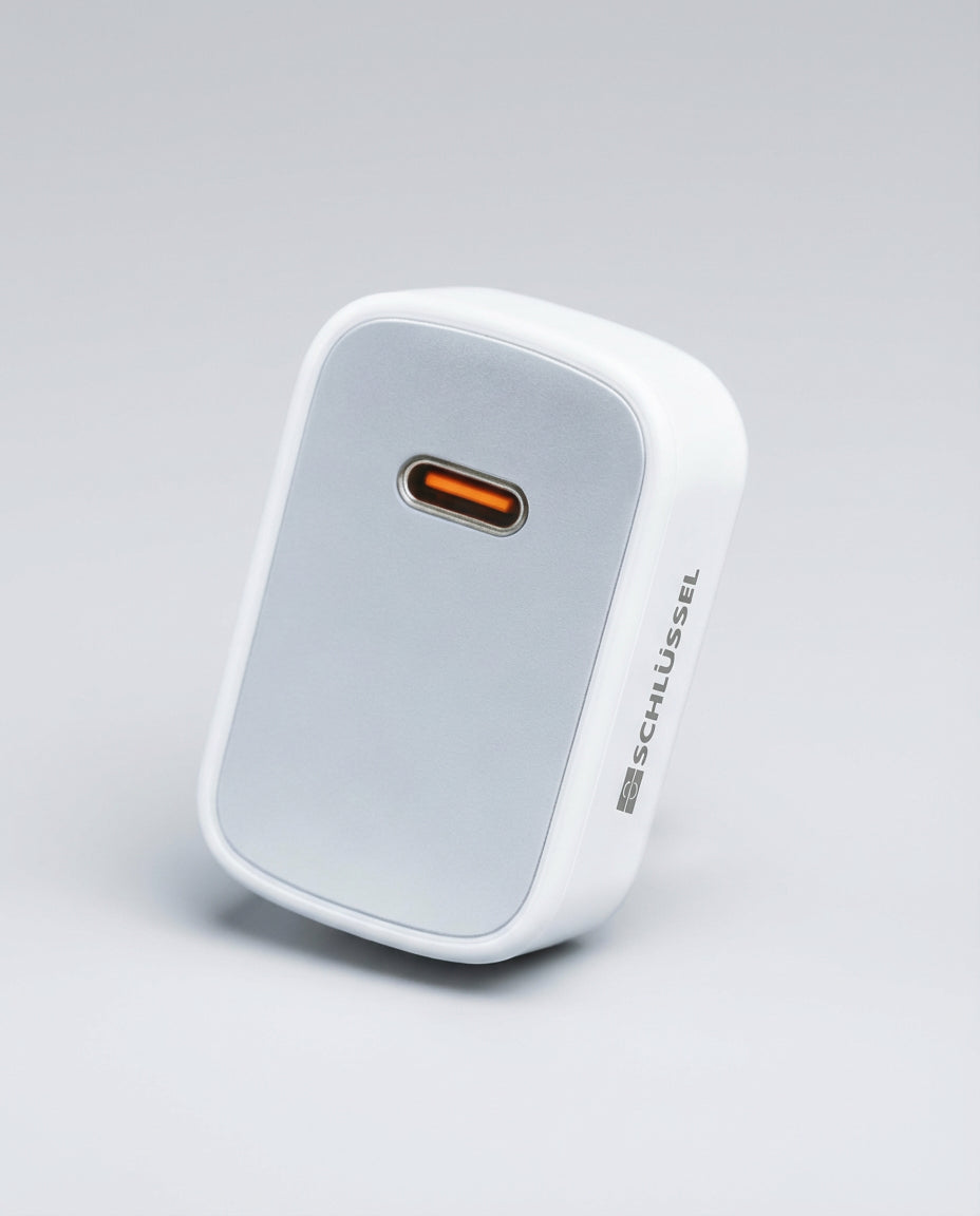 Schlussel compact white USB-C wall charger with fast charging capability.