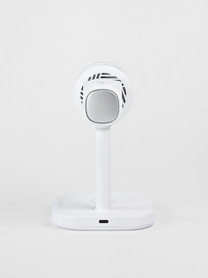 Rear view of the white Schlüssel 3-in-1 wireless charging station, showcasing the USB-C power input port at the base and a silver metallic module on the back against a light gray background.