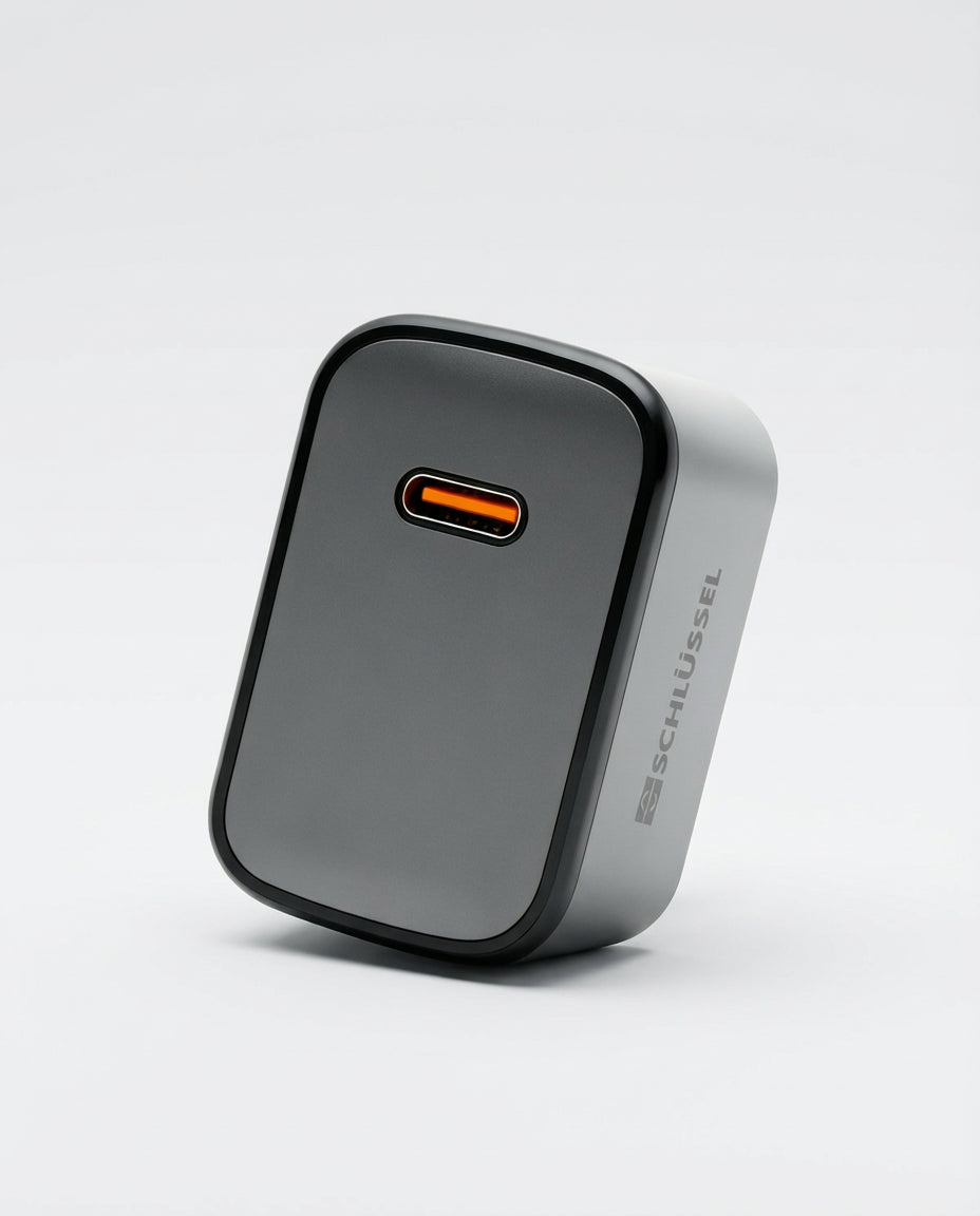 Schlussel compact black USB-C wall charger with fast charging port and minimalist design.