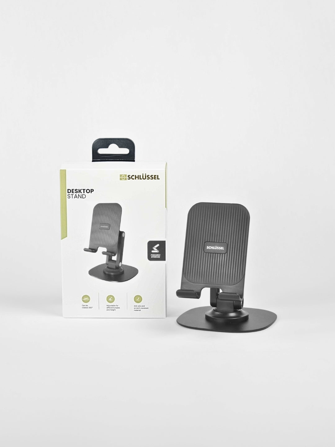 Black Schlüssel adjustable desktop phone stand displayed next to its product retail packaging box against a clean light gray background