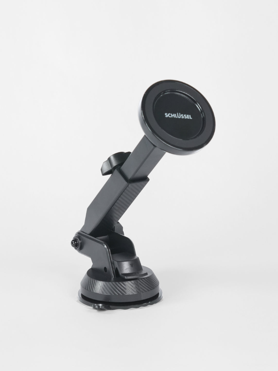 A standalone black Schlüssel magnetic car phone holder with an adjustable telescopic arm and heavy-duty suction cup base, isolated against a light gray background