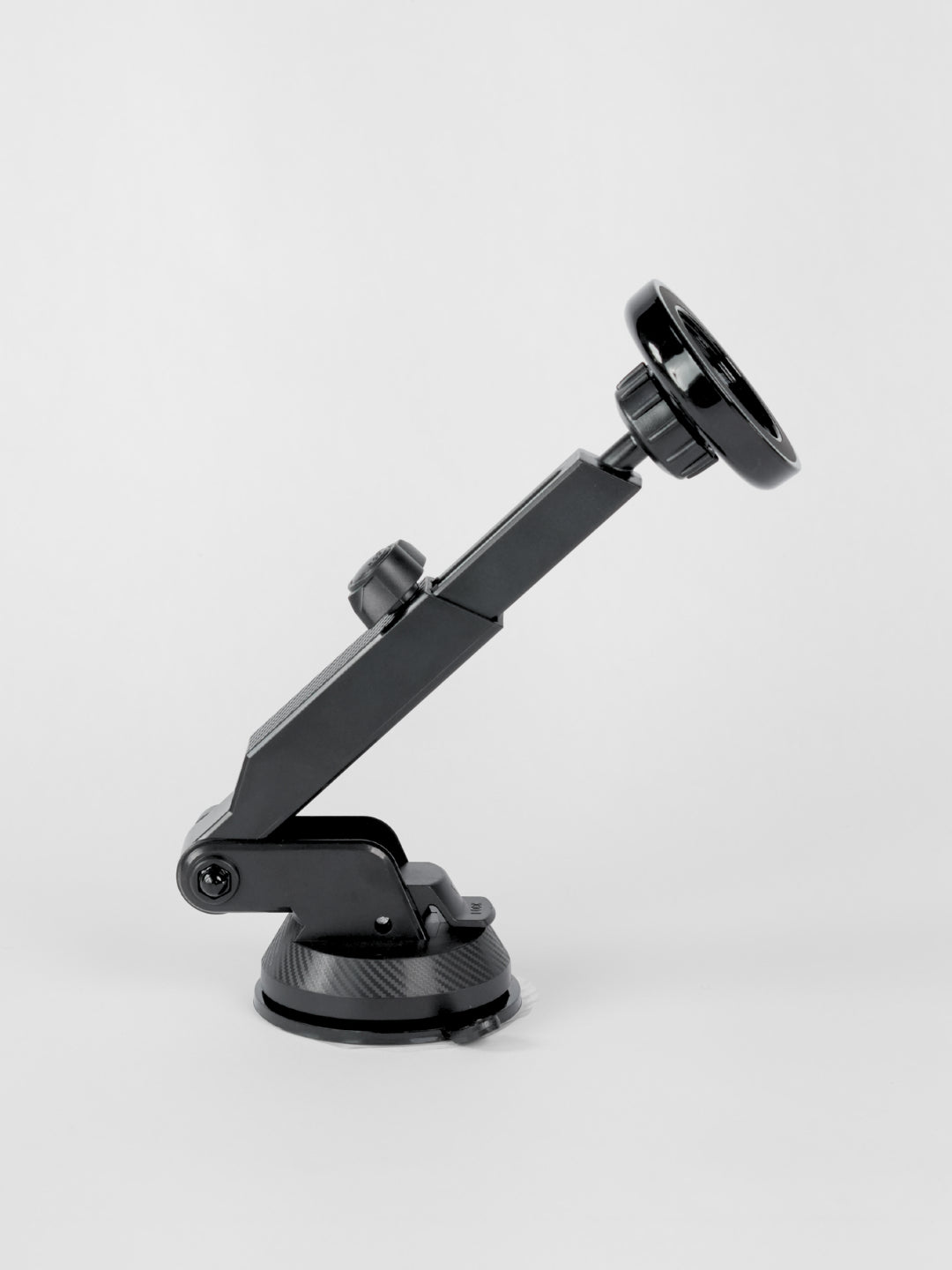 Side profile view of the black Schlüssel magnetic car phone holder, detailing its adjustable telescopic extension arm, ball-joint head, and suction cup base against a gray background