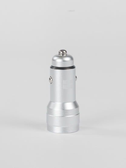 A standalone silver metallic Schlüssel car charger adapter standing vertically, showcasing its premium aluminum finish and metal contact points against a clean, light gray background.