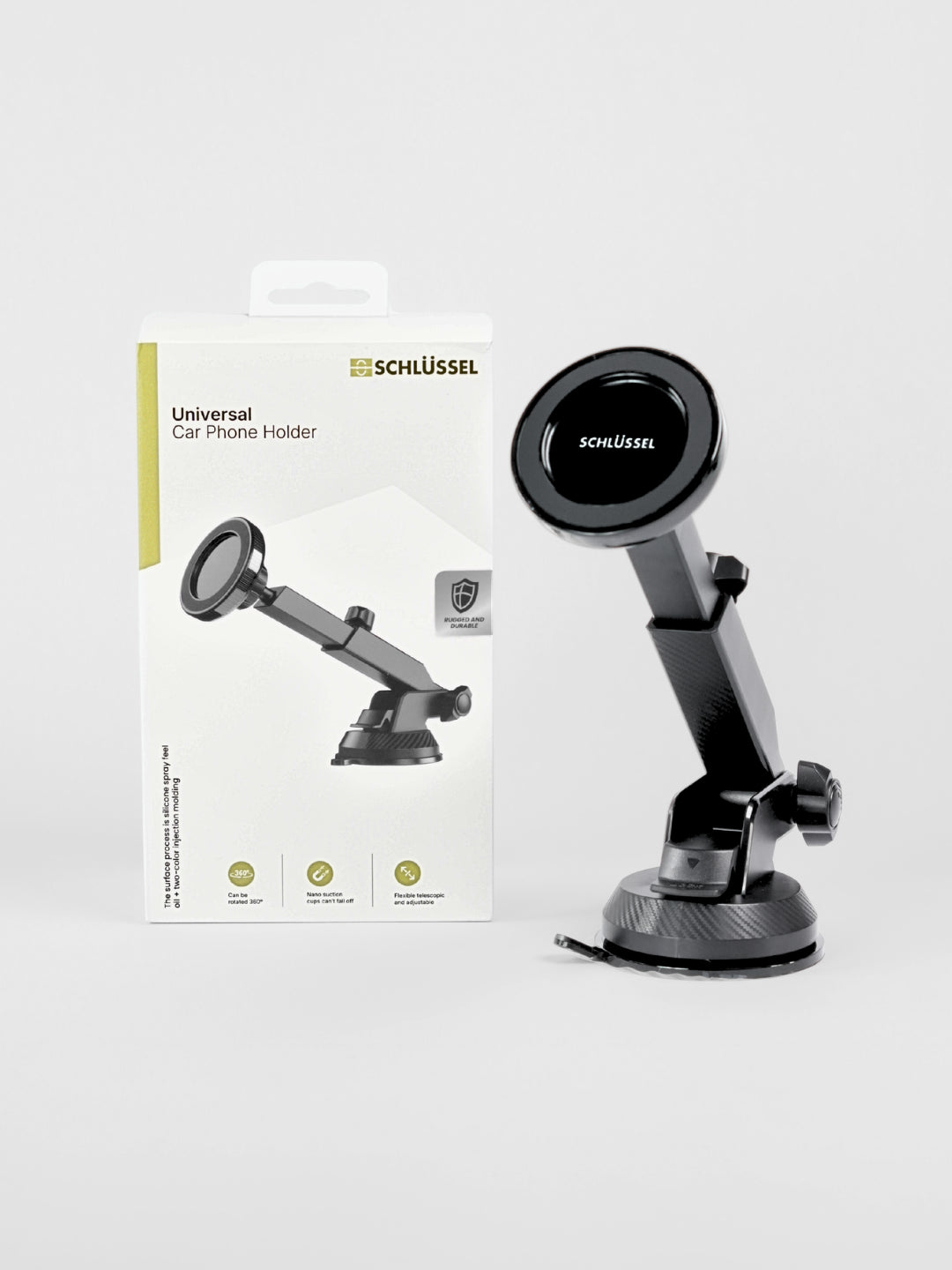 Schlüssel black universal magnetic car phone holder with an adjustable telescopic arm and suction cup base, displayed next to its product packaging on a clean light gray background